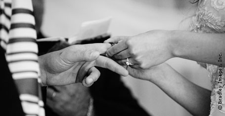 Photograph: Bride putting ring on the groom's finger